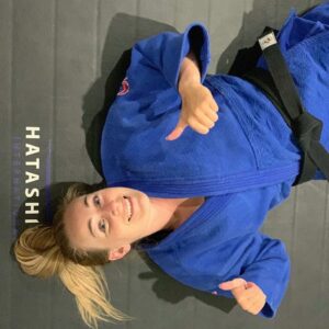 woman lays on mat after karate