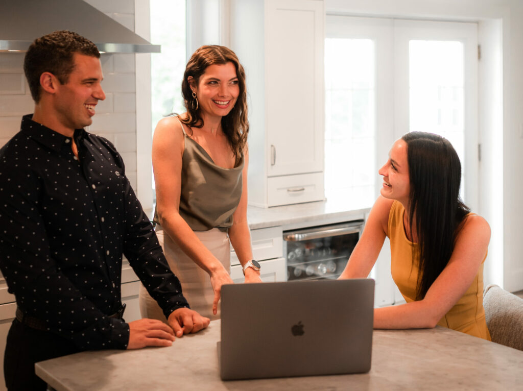 three realtors discuss housing around a table