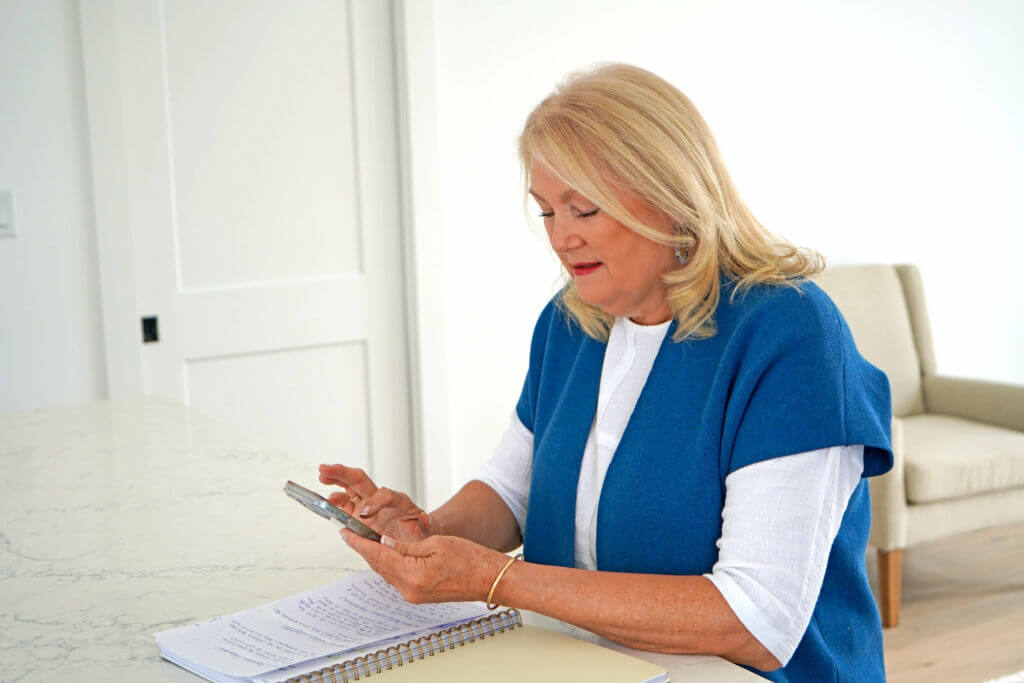A realtor works on her phone. It's why you should always use a realtor.