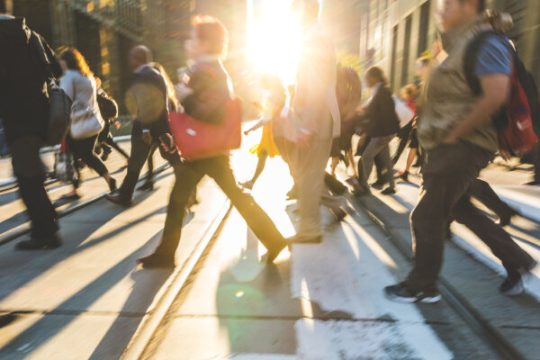 Blurred people crossing street, background