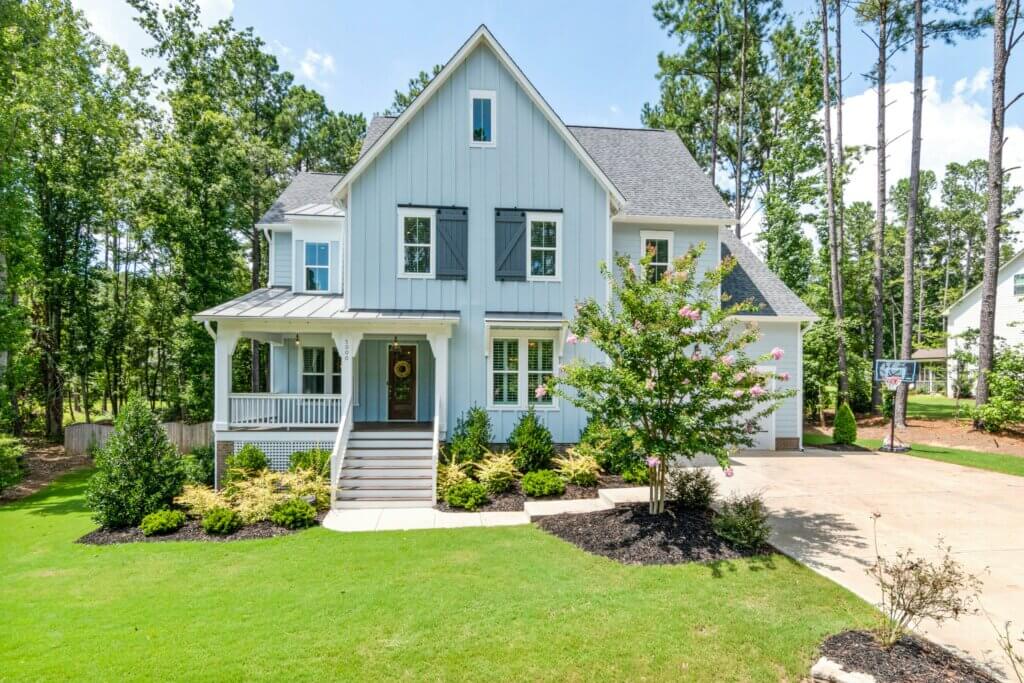 a blue house sitting on a manicured lot in Belleville Ontario