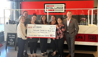 agents presenting large cheque to shelter organization