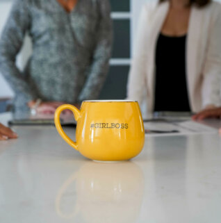 davies and co real estate team with yellow girl boss mug